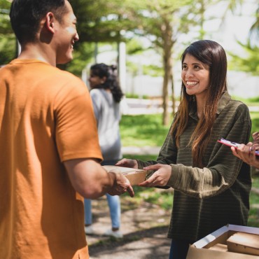 volunteers handing out packed lunches