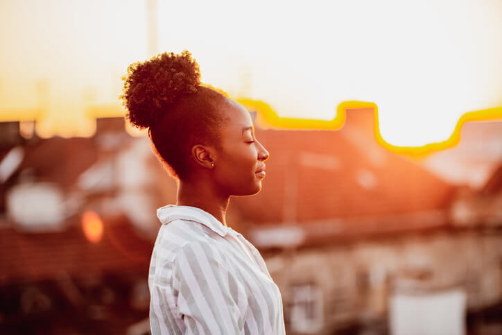 Young African American woman relaxing on the rooftop