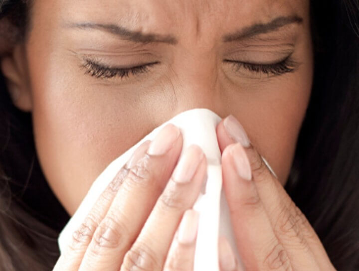 woman sneezing