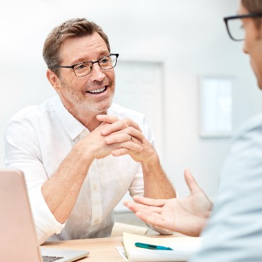 Employer discussing group health insurance benefits with broker