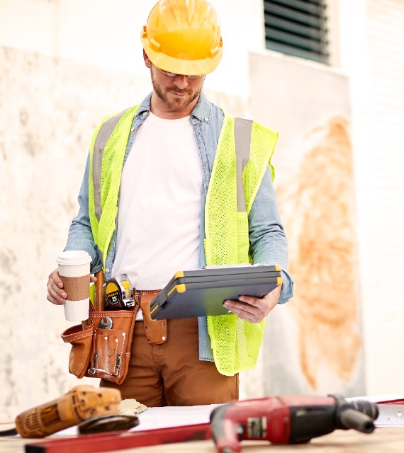 construction employee reviewing benefits package on tablet
