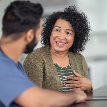 woman discussing Medicaid coverage with a doctor