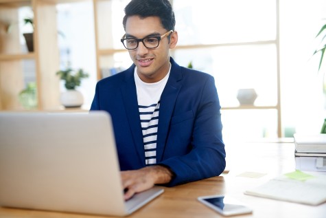 Man in glasses at laptop