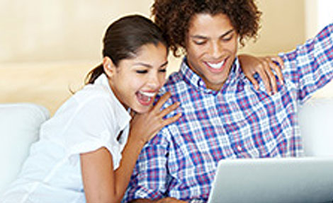 young couple looking at laptop
