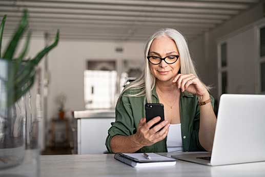 woman looking at her phone requesting PHI via a mobile app
