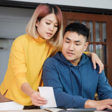 young couple looking at budget together